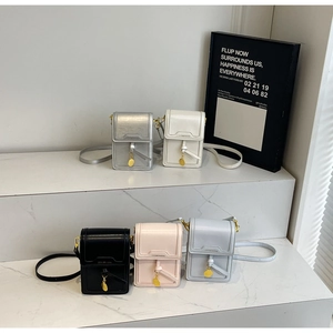 Detailed view of 5 colorful crossbody phone bags on a modern marble display
