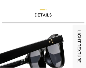 Detail of black frame sunglasses with three gold triangular rivets and light texture