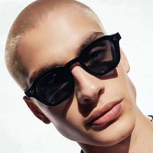 Classic black thick-frame sunglasses with silver rivet accents worn by a male model