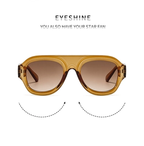 Detail of amber tortoiseshell sunglasses with gradient brown lenses and integrated nose pads