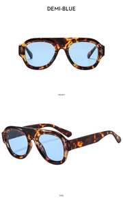 Front and side views of oversized demi-blue sunglasses with thick tortoiseshell frames