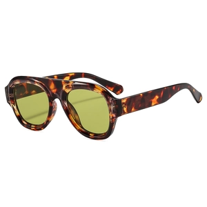 Oversized tortoise frame sunglasses with yellow-green lenses at 45-degree angle