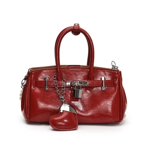 Glossy red handbag with silver lock, heart pendant and pearl details for women