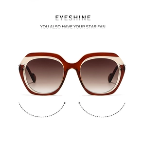 Detailed close-up of stylish brown tortoiseshell oversized sunglasses with gradient lenses