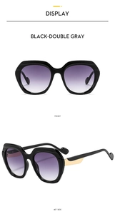 Detail view of butterfly sunglasses with black frames and purple-grey gradient lenses