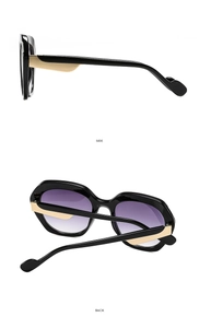 Side and back view of black chunky sunglasses with purple gradient lenses and gold accents