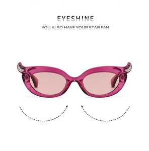Detail view of pink cat-eye sunglasses featuring stylish metal rivets on a clear frame