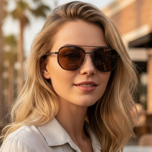 Classic double-bridge metal polarized sunglasses with brown lenses worn by model outdoors