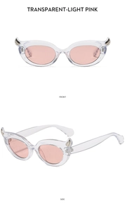 Front and side detail of transparent light pink cat-eye sunglasses with metal accents