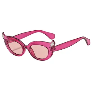 Fashionable cat eye sunglasses with pink translucent frame and devil horn design
