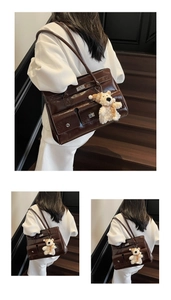 Detail of dark brown glossy tote bag with flap pocket and cute white plush bear pendant