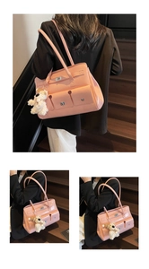 Detail of pink patent leather handbag with silver lock and plush dog charm
