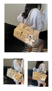Detail of beige faux leather tote bag showing silver metal turn-lock and plush bear charm