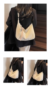 Detail of cream canvas tote bag featuring pleated half-moon design and woven rope charm