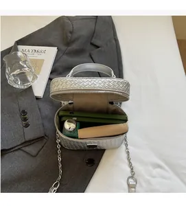 Top view of silver woven crossbody bag interior showing spacious storage for makeup and phone