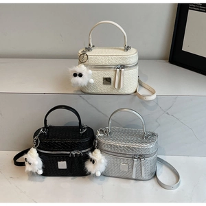 Detailed macro view of woven texture crossbody bags in white, black and silver finishes