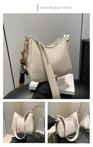 Detail of white lychee pattern leather shoulder bag with a cute rabbit doll charm