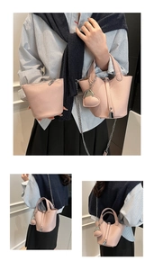 Pink lychee grain leather bucket bag set with silver chain and heart charm detail