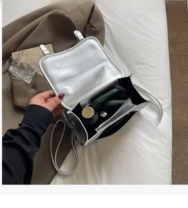 Detail view of the silver PU leather crossbody bag interior with large storage capacity