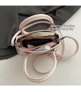 Internal view of a light pink crossbody bag showing spacious capacity for essentials