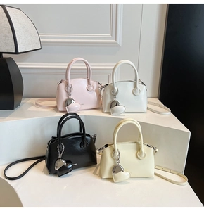Mini handbag display in pink white black and cream colors with heart charms