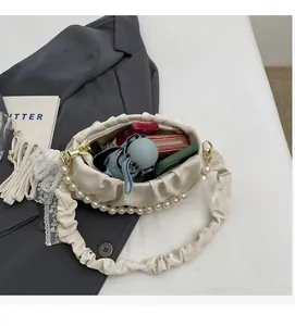 Interior view of pleated cloud bag showing capacity for umbrella and wallet