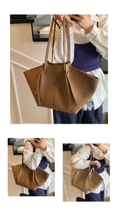 Close-up of litchi texture brown tote bag with stylish knot detail on the strap