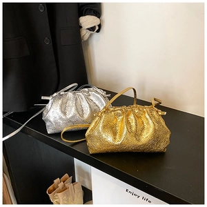 Detailed close-up of metallic faux snake pattern and ruching on gold and silver bags