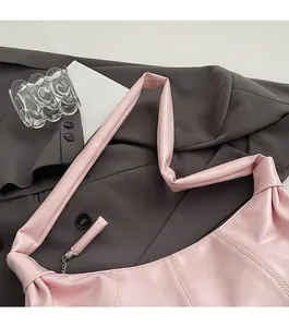 Close-up of pink pleated leather dumpling bag texture with wide shoulder strap