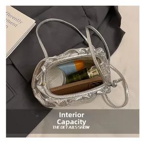 Internal capacity of silver crocodile pattern crossbody bag showing daily essentials