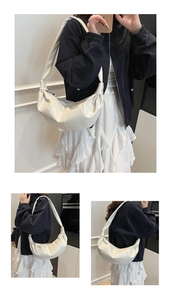 Detail view of beige crescent dumpling bag with pleated soft leather texture and wide strap