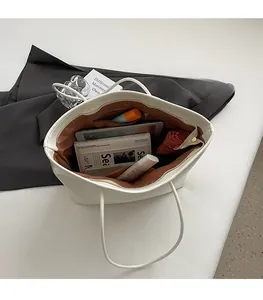 Internal view of the white tote bag showing spacious compartments and storage capacity