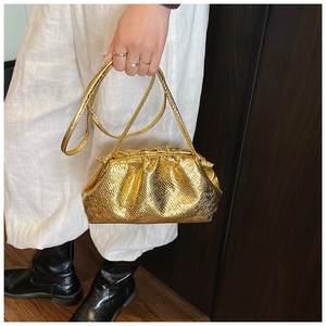 Detail of metallic gold cloud pouch with snake texture and pleated dumpling design