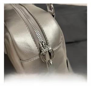Close-up of high-quality silver metal zipper and textured metallic leather on the bowling bag