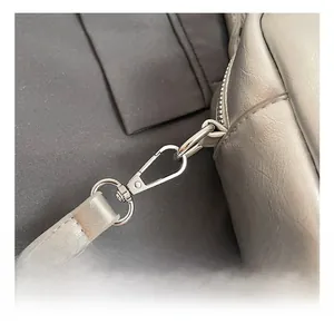 Macro shot of high-quality silver metal hook and leather strap texture on bowling bag