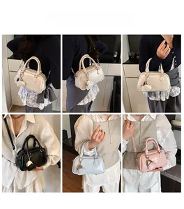 Fashionable mini bowling bag shown in various styles with heart pendant and shoulder straps