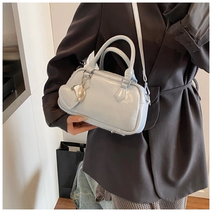Close-up of light blue bowling bag with glossy finish and heart pendant detail