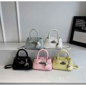 Detail view of colorful bucket bags with lychee grain texture and metal heart charms