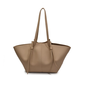Minimalist tan lychee-textured wing tote bag with knotted shoulder straps on white background