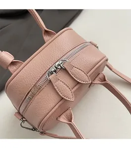 Detailed shot of smooth dual zippers and litchi texture on pink Boston handbag