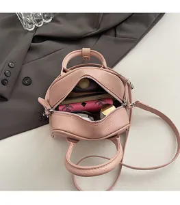 Detail view of pink pebble grain leather Boston bag showing spacious inner compartment