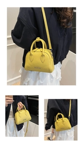 Detailed views of yellow lychee leather mini Boston bag with metal logo and zipper closure