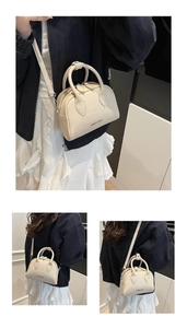 Detail of off-white litchi texture leather mini bowling bag with silver hardware