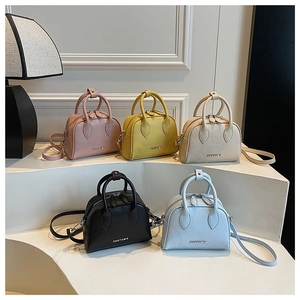 Group of colorful lychee grain leather mini bowling bags shown in five vibrant colors