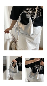 Close-up of silver oil wax leather hobo bag featuring a pearl bow charm and reinforced handle