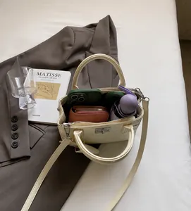 Interior view showing the large capacity and storage space of the cream handbag