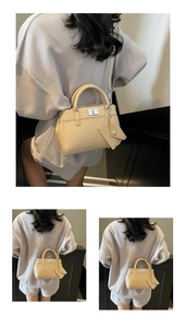 Detail of beige rectangular handbag with silver twist lock and mini triangle pouch accessory