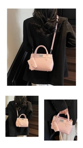 Detail view of pink glossy leather handbag with silver lock and mini envelope charm
