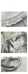 Detail of silver metallic leather handbag with white lace heart and checkered bow