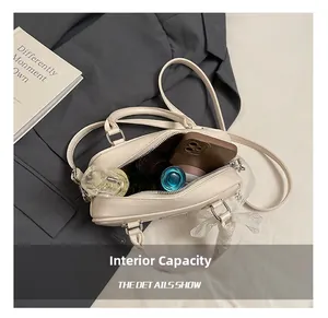 Internal capacity of beige Boston bag showing space for phone and cosmetics